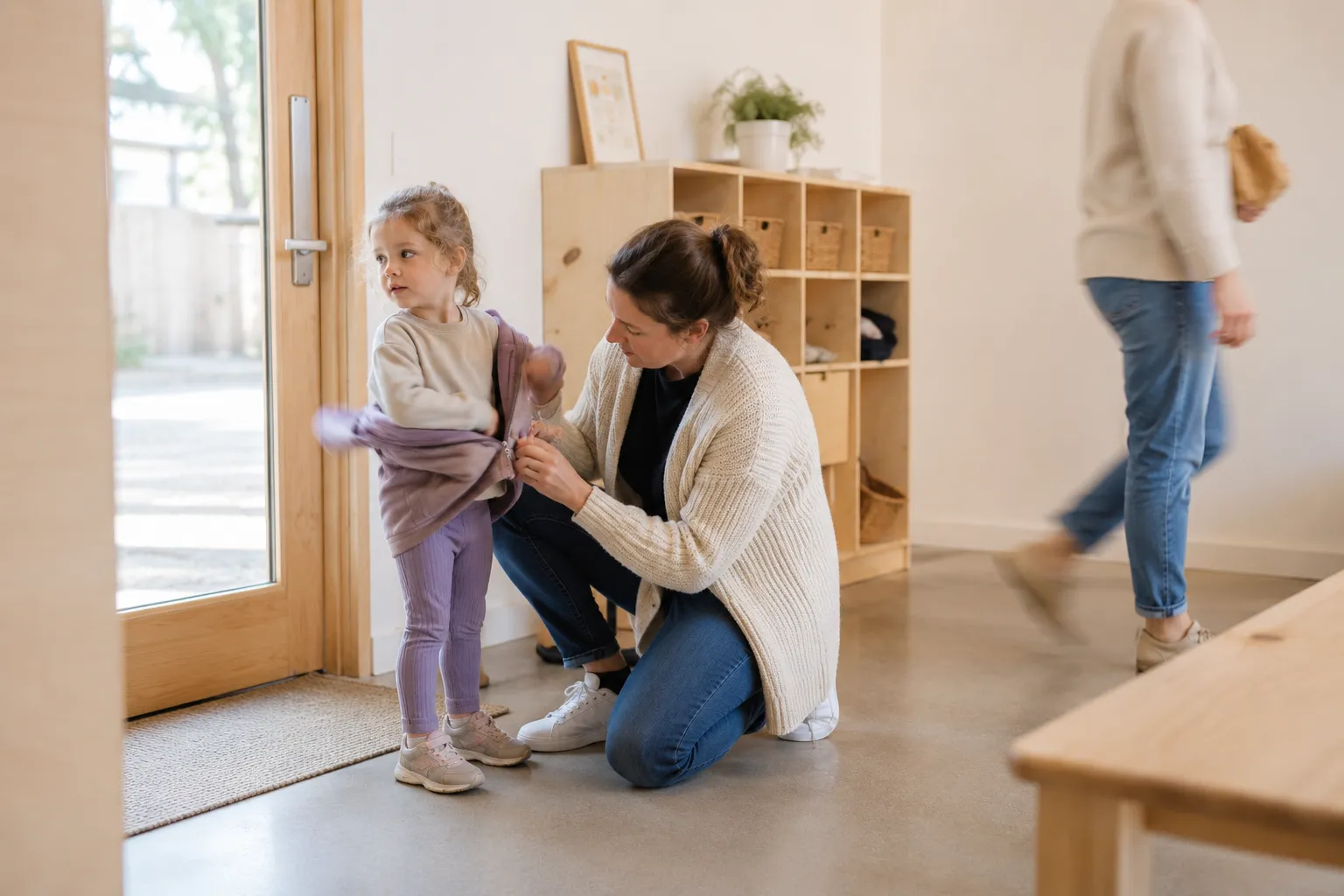 Educator welcoming a child and parent